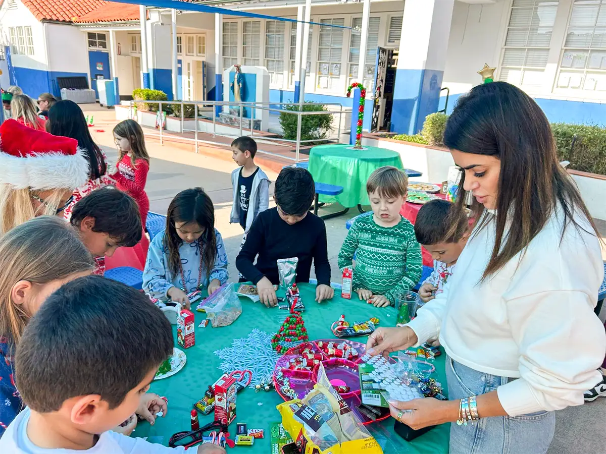 An adult supervises Christmas crafts