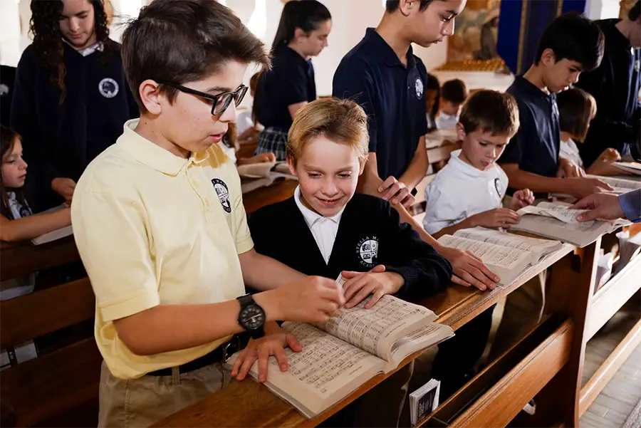 Students in church with a songbook