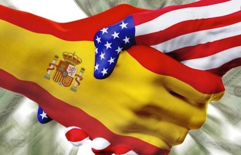 Handshake - one with a Spanish flag and the other with an American Flag
